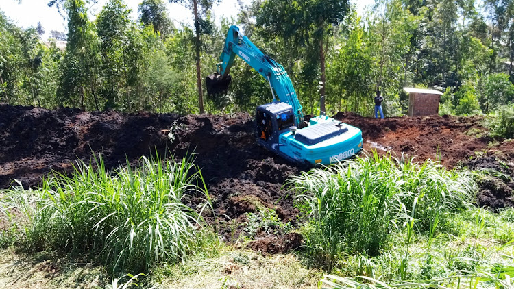 An excavator clears one of the disused sewage lagoons grabbed by developers at Site and Service scheme in Kakamega town.