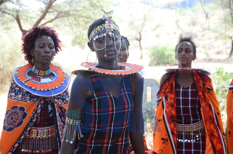 Hellen Seko and Lorna Nkinyiai dance in celebration