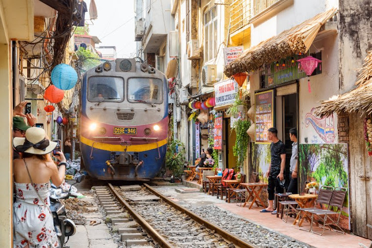 A train passes through a narrow street in the Hanoi Old Quarter in Hanoi, Vietnam. Vietnam has one of the most energy-intensive economies in the world. Picture: 123RF/EFIRED