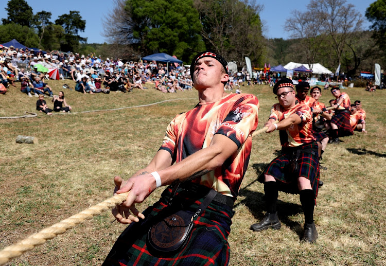 Firefighters engage in a tug of war challenge.