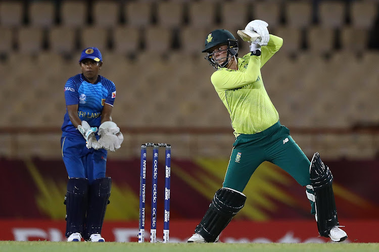 Marizanne Kapp of South Africa hits the ball towards the boundary, as Dilani Manodara of Sri Lanka looks on during the ICC Women's World T20 2018 match between Sri Lanka and South Africa at Darren Sammy Cricket Ground on November 12, 2018 in Gros Islet, Saint Lucia.