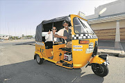 FILE PICTURE: Khanyi Pupuma takes Shanaaz Prince for a spin in his newly launched tuk-tuk taxi service. He hopes to provide the Beacon Bay area with greener, safer and more fun transport Picture: STEPHANIE LLOYD 23/6/2013 © Daily Dispatch.