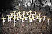 MEMORIAL: Twenty-seven wooden angels in a wooded area near the Sandy Hook Elementary School in commemoration of the victims of the massacre in Newtown, Connecticut, on Friday. The first funerals, of two six-year-old boys, were held yesterday