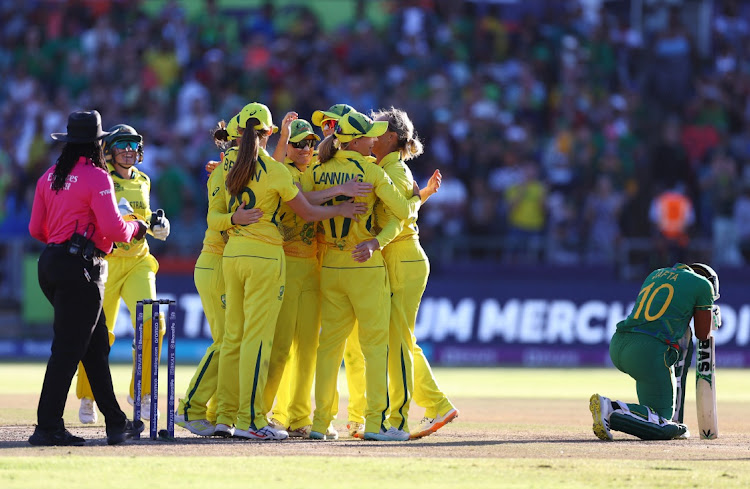 Australia's players celebrate after inning the ICC Women’s Cricket T20 World Cup final against South Africa at Newlands in Cape Town on February 26 2023.