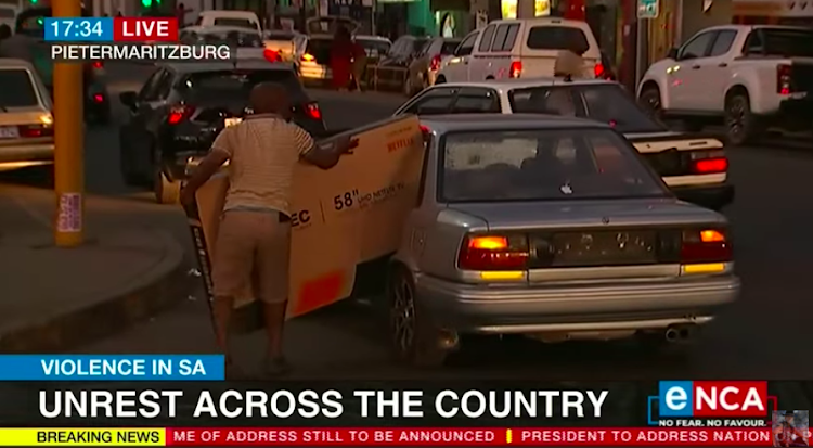 The man in the video tries to fit a 58-inch flat-screen into his car.