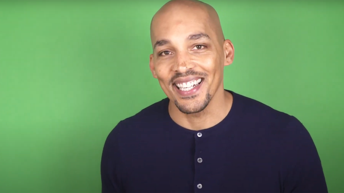 Still frame of Light Watkins in front of a greens studio backdrop.