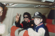  Michael Jackson with 10-year-old James Safechuck on a tour plane on July 11 1988. 