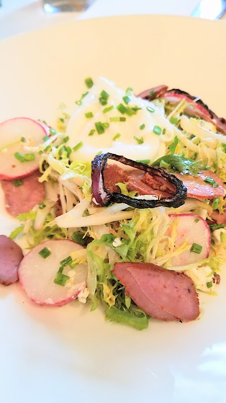 Jake's Grill and Anderson Ranches Lamb Pasture to Plate specials menu house smoked lamb pastrami salad with poached local farm egg, double crème goat cheese, frisée lettuce, and red wine vinaigrette