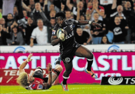 TWINKLE TOES : The Sharks' Lwazi Mvovo charging past the Lions' Willie Britz to score a try during their Super Rugby match at Ellis Park in Johannesburg on Saturday Photo: Gallo Images