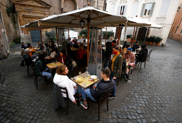 People sit at a restaurant in Trastevere after the coronavirus disease (COVID-19) restrictions were eased in Lazio region, Rome, Italy, February 1, 2021. Picture: REUTERS/GUGLIELMO MANGIAPANE