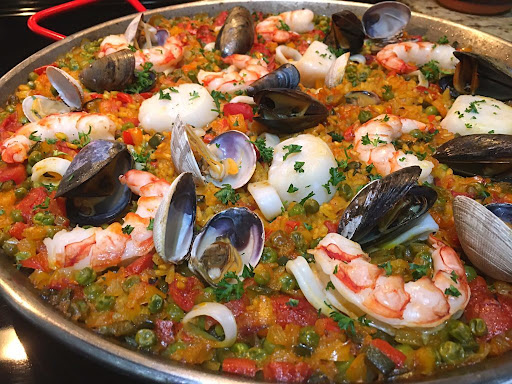 A beautiful paella with calamari rings, mussels, clams, prawns and scallops