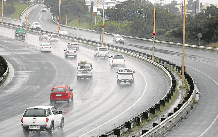 Motorists negotiate wet roads along the North East Expressway, East London.