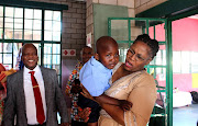 KwaZulu-Natal education MEC Mbali Frazer consoles Ndaba, 5, alongside education HOD Nkosinathi Ngcobo at Kwa-Zubumnandi preschool in Umlazi on Wednesday.