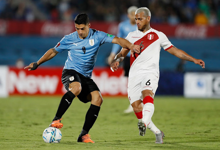 Uruguay's Luis Suarez in action with Peru's Miguel Trauco in past action