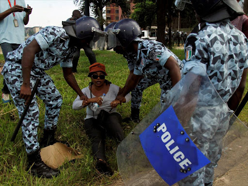 A member of the opposition is detained during a march to protest against Ivory Coast's President Alassane Ouattara's new constitution in Abidjan, Ivory Coast, October 20, 2016. /REUTERS