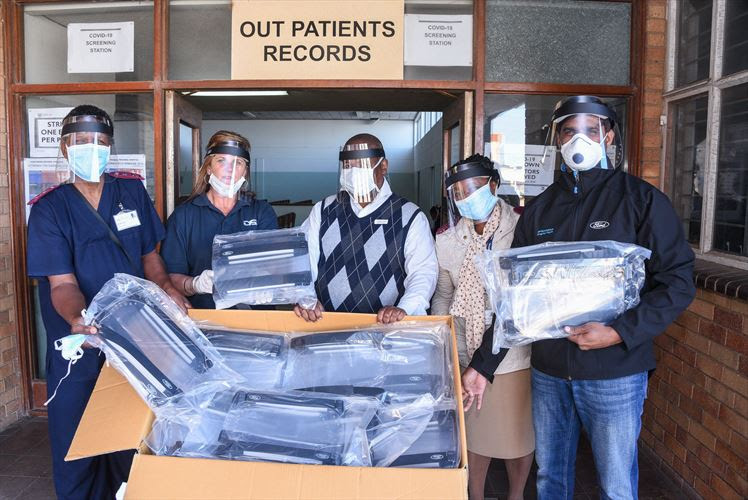 Ford employees hand over a batch of protective face shields to staff at Dora Nginza Hospital in Port Elizabeth