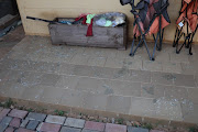 Broken glass outside the house of  Nhlanhla Lux 'Dlamini's' neighbour in Pimville, Soweto. 