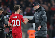 Diogo Jota of Liverpool celebrates with manager Jurgen Klopp after the Premier League match between against Leicester City at Anfield in Liverpool on February 10 2022.