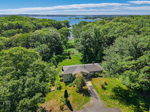House surrounded by trees, view of water in this luxury house for sale in Cushing ($550,000)