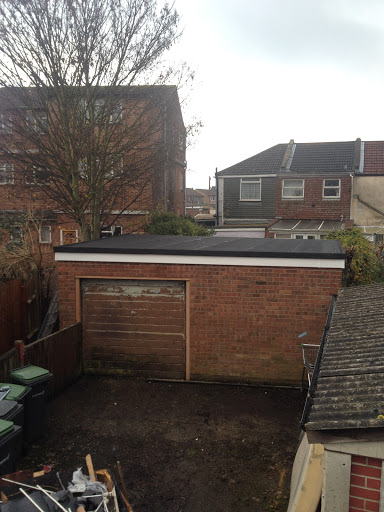 Finished result of a new flat roof with new decking and three layers of torch on felt.