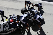 Pierre Gasly of France driving the (10) Scuderia AlphaTauri AT02 Honda is pushed back into the garage during Day Three of F1 Testing at Bahrain International Circuit on March 14, 2021 in Bahrain, Bahrain.