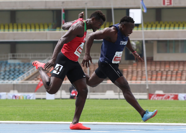 Mark Otieno (L) and Ferdinand Omanyala (R) race to the finish line during the men's 100m final at Moi Stadium, Kasarani.