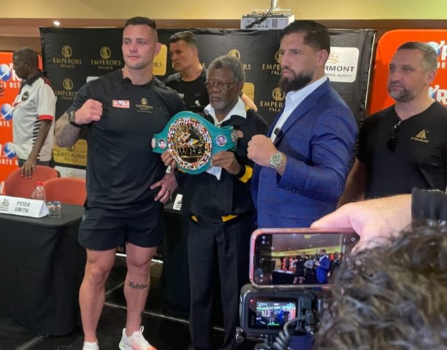 Kevin Lerena and Senad Gashi pose along the WBC belt held by Dr Peter Ngatane. Behind Lerena is his trainer, Peter Smith, while coach Sergei Ostrovski stands to the right of the German. In the background on the left is South Africa's former WBC super-middleweight champion Sugar Boy Malinga.