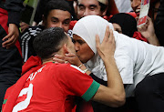 Achraf Hakimi of Morocco is seen with a family member who has been identified as his mother at full time of their World Cup last-16 win against Spain at Education City Stadium in Al Rayyan, Qatar on December 6 2022.