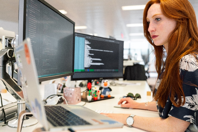 Image of female software engineer coding at computer