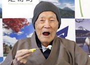 Japanese Masazo Nonaka, who was born 112 years and 259 days ago, eats his favorite cake as he receives a Guinness World Records certificate naming him the world's oldest man during a ceremony in Ashoro, on Japan's northern island of Hokkaido, April 10, 2018. 