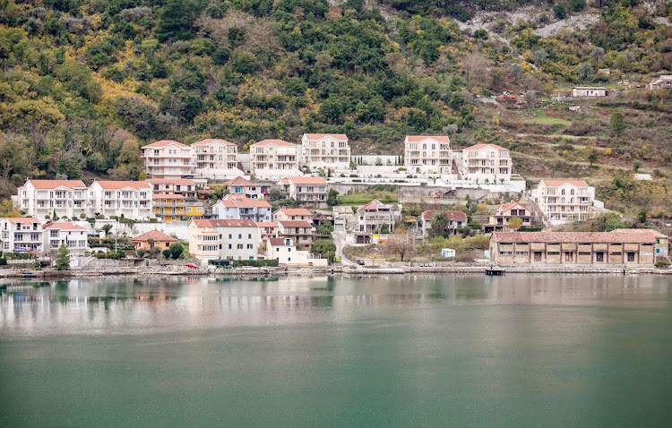 Buildings line the pretty shoreline of Kotor, Montenegro, 