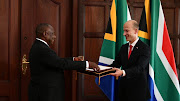 The ambassador designate of Germany, Andreas Peschke, hands over a letter of credence to President Cyril Rampahosa at the Sefako M Makgatho presidential guesthouse on Tuesday.