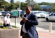 Former eThekwini municipal manager Sipho Nzuza arrives at the Durban high court on Monday, where he faces charges of fraud, corruption, money laundering and racketeering related to an irregular Durban Solid Water tender.