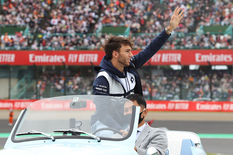 Pierre Gasly of France and Scuderia AlphaTauri waves to the crowd on the drivers parade prior to the F1 Grand Prix of Japan on October 9, 2022 in Suzuka