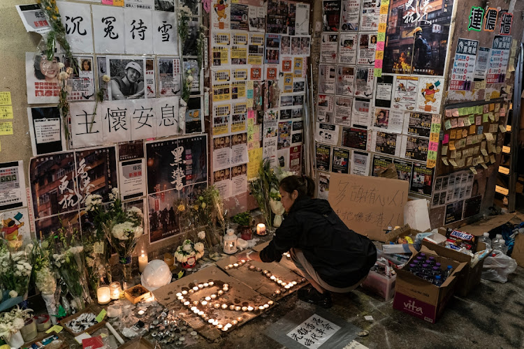 A woman pays her respect to student Alex Chow on November 10 2019 in Hong Kong. Picture: GETTY IMAGES/ANTHONY KWAN