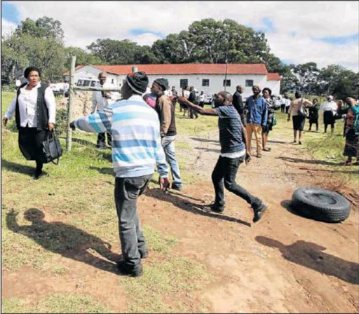 GRIEVANCES: Tensions flared between feuding factions of the Presbyterian Church of Southern Africa in Ross Mission on Sunday. The church gates were barricaded with burning tyres. Picture: LULAMILE FENI