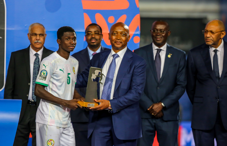 Senegal midfielder Lamine Camara receives his the Man of the Tournament award from Caf president Patrice Motsepe during the U-20 Africa Cup of Nations final at Cairo International Stadium on March 11 2023 in Cairo, Egypt. File photo.