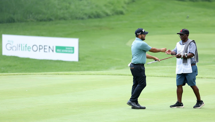 Hennie du Plessis of South Africa hands his putter to his caddie on the 18th hole during day one of the MyGolfLife Open hosted by Pecanwood at Pecanwood Golf & Country Club on March 10 2022 in Hartbeespoort. Picture: GETTY IMAGES/WARREN LITTLE