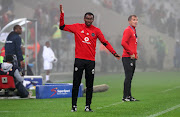 Orlando Pirates assistant caoch Rhulani Mokwena (L) reacts alongside head caoch Milutin Sredojević (R) during the Nedbank Cup Last 16 match against Cape Town City FC at Cape Town Stadium in Cape Town on 14 March 2018.