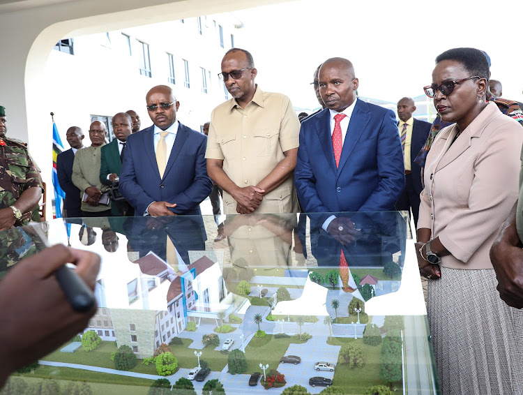 Defence CS Aden Duale and his Interior and National Administration counterpart Prof Kithure Kindiki being taken through the design of Kenya Prisons Service Wanini Kireri Magezera Level IV Hospital on may 17, 2024.