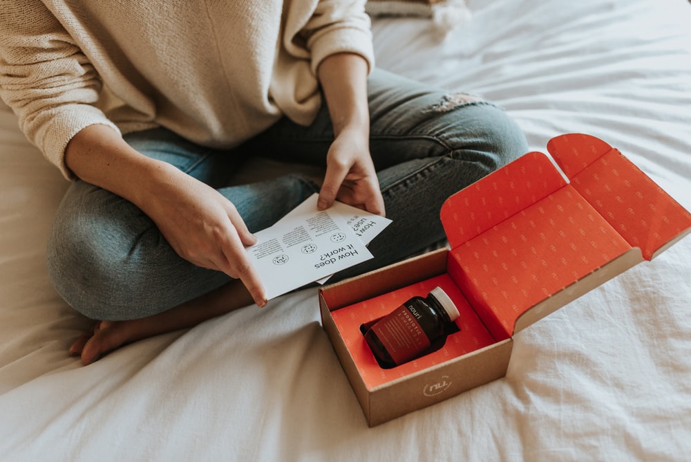 red-labeled amber glass tub on a box