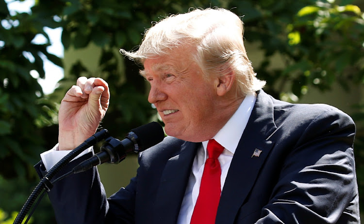 US President Donald Trump refers to amounts of temperature change as he announces his decision that the United States will withdraw from the landmark Paris Climate Agreement, in the Rose Garden of the White House in Washington, US, on June 1, 2017.