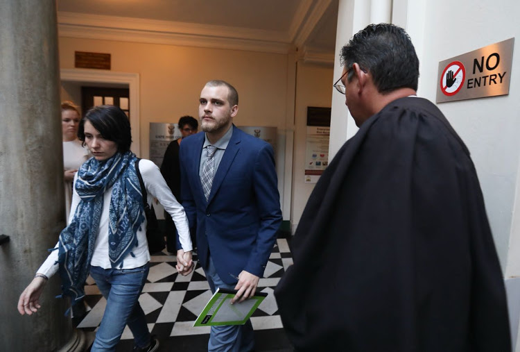 Henri van Breda and his girlfriend Danielle Janse van Rensburg leave the court room for tea break.