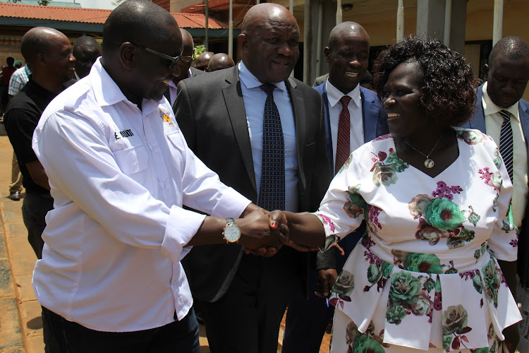 Ekuru Aukot shakes hands with Angurai South MCA Grace Omasete outside the assembly on Wednesday. Looking on are speaker Bernard Wamalwa and his deputy Lawrence Okaale.