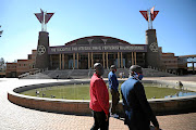 Members of International Pentecos Holiness Church walk the grounds of the church's headquarters at  Zuurbekom, west of Johannesburg, were a shooting took place. 