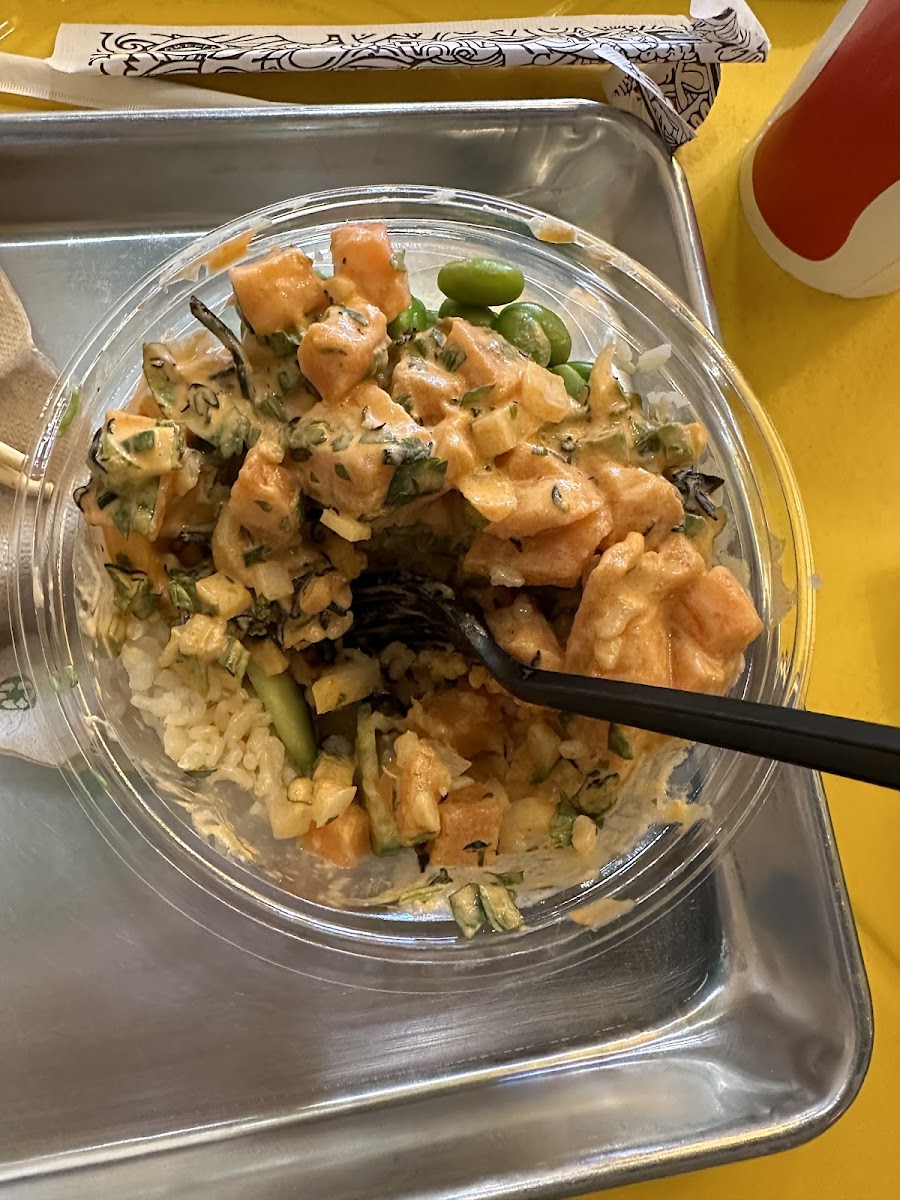 Salmon poke bowl with brown rice and spicy aioli.