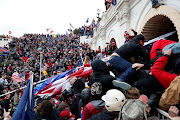 Pro-Trump protesters storm into the US Capitol during clashes with police during a rally to contest the certification of the 2020 US presidential election results by the US Congress in Washington. 