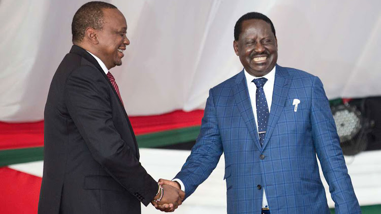 President Uhuru Kenyatta shakes hands with the ODM leader Raila Odinga.
