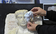 A replacement part is fitted to one of the funerary busts smashed by IS in Palmyra.