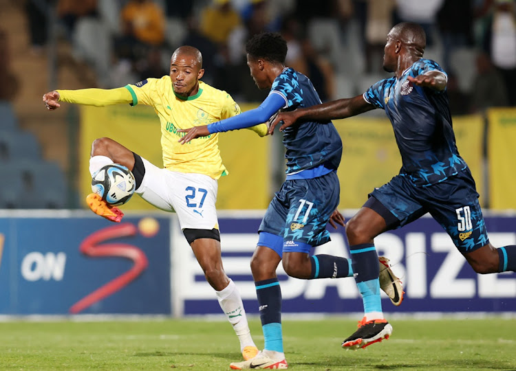 Thapelo Morena of Mamelodi Sundowns is challenged by Ntsikelelo Ngqonga and Ntsikelelo Nyauza of Moroka Swallows in the DStv Premiership match at Dobsonville Stadium on Monday.